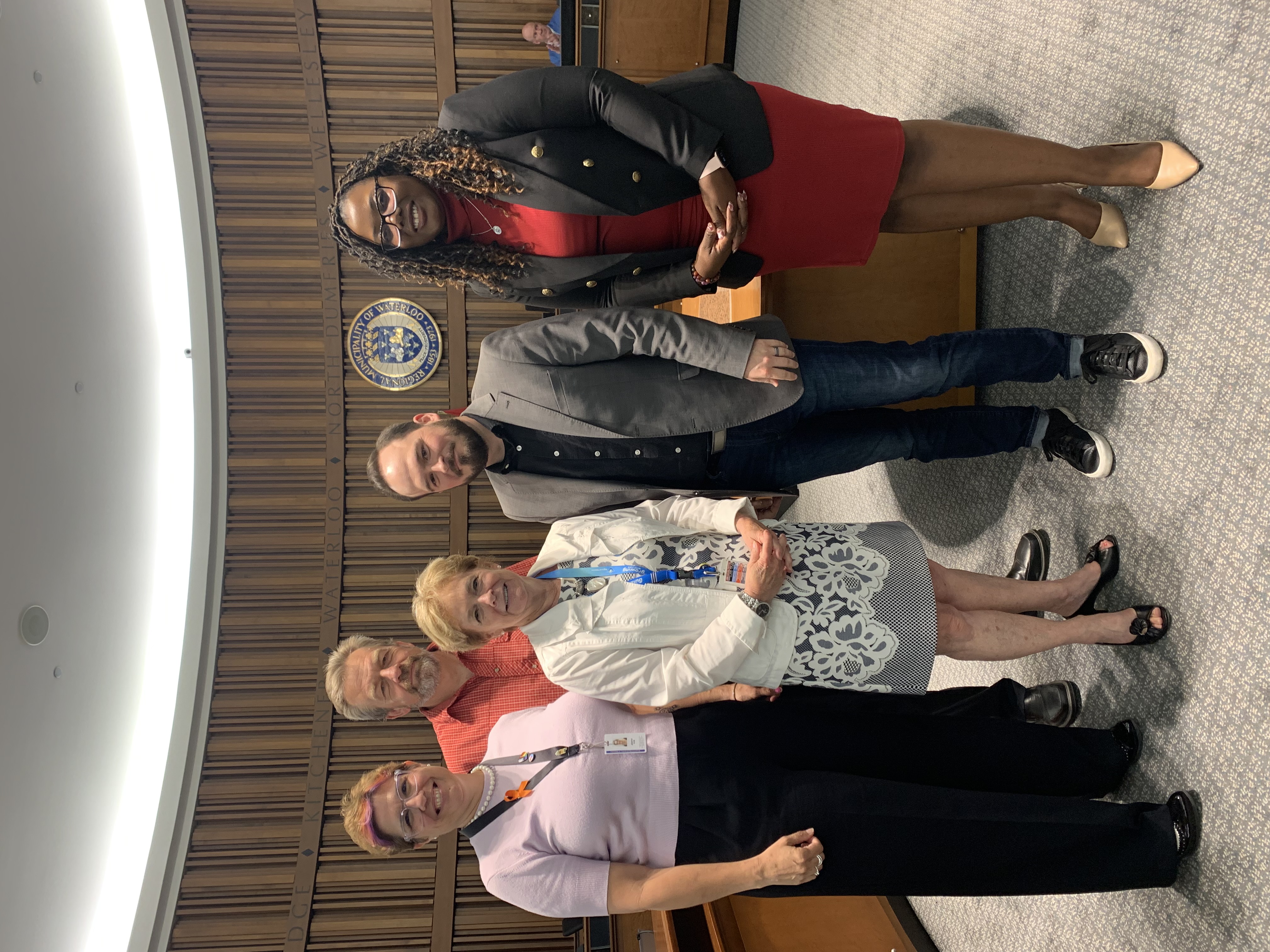 Photo of Councillor James and Chair Redman with staff involved in the award