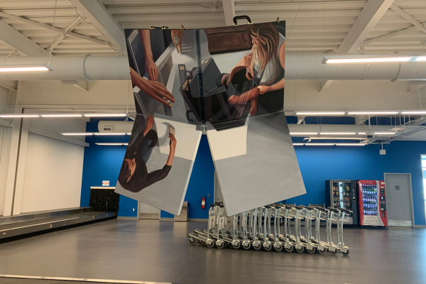 A painting hanging from the roof that folds into a suitcase