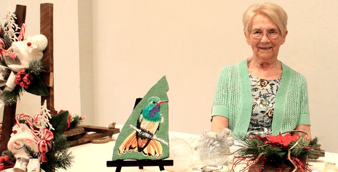 Senior sitting at table with crafts