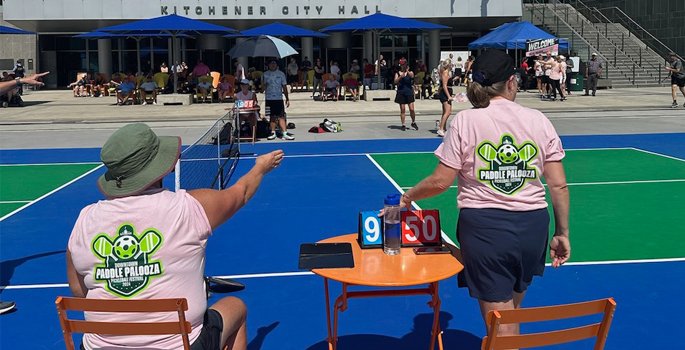 Two pickleball convenors near court