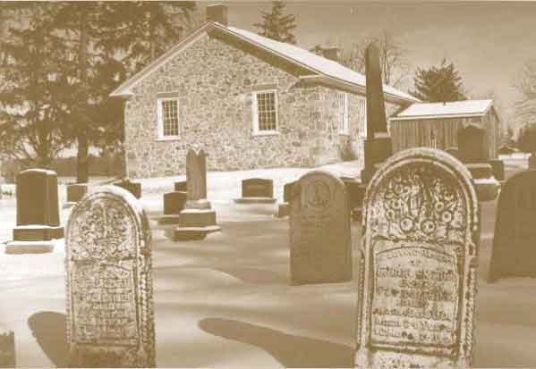 stone house and tombstones